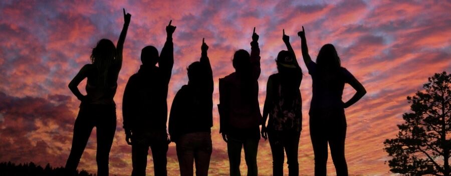 Six Students standing in silhouette Six Students standing in silhouette
